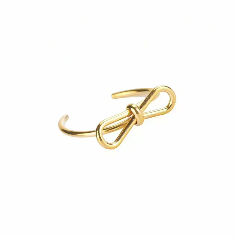 Anillo Alicia Vanytel ajustable en acero inoxidable dorado con diseño de lazo elegante.
